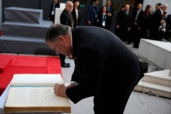 U.S. Secretary of State Mike Pompeo signs a guest book during a memorial service marking the death of 85 people who died in a 1994 bombing blamed on Hezbollah, in Buenos Aires, Argentina, Friday, July 19, 2019.