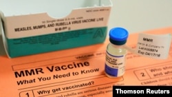 FILE PHOTO: A vial of measles, mumps and rubella vaccine and an information sheet is seen at Boston Children's Hospital in Boston