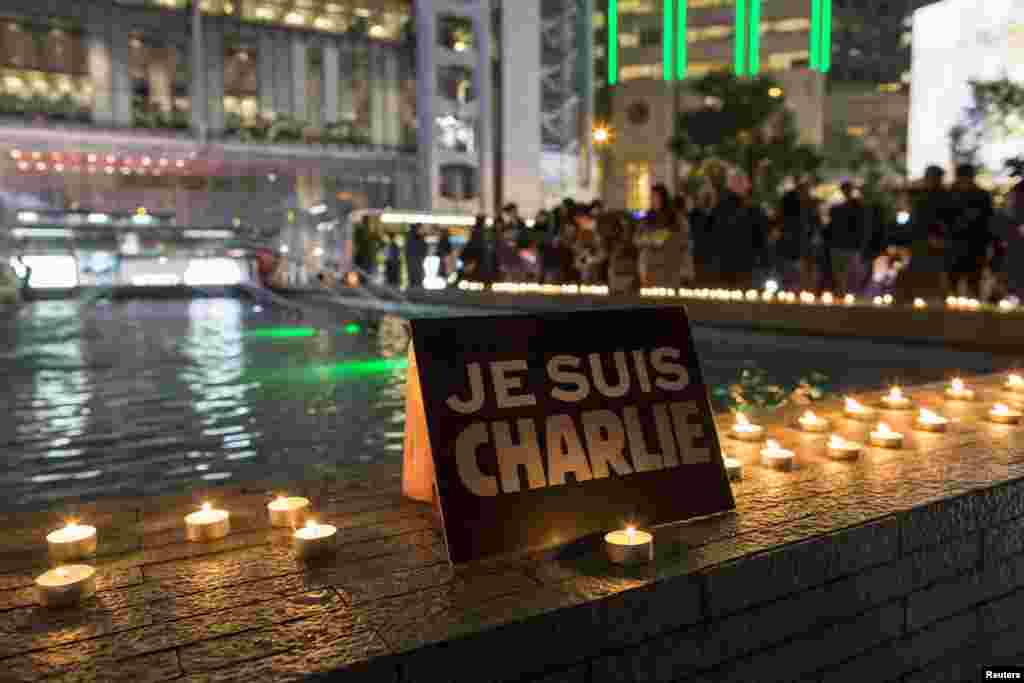 A placard reading "I am Charlie" and candles are placed as a tribute during a candlelight vigil at the financial Central district in Hong Kong, Jan. 9, 2015.