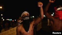 Demonstrators protest the shooting death of Michael Brown, in Ferguson, Missouri August 19, 2014.