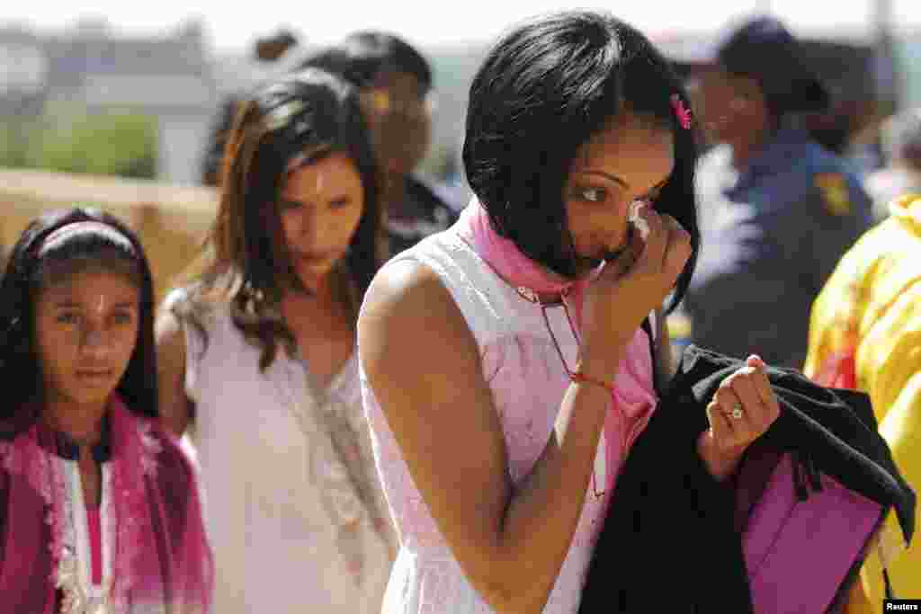 A woman weeps after paying her respects to Nelson Mandela as Mandela lies in state for the second day at the Union Buildings in Pretoria, Dec. 12, 2013. 
