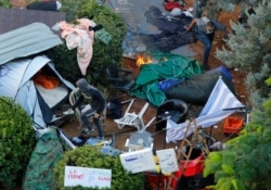 Hezbollah supporters burn tents in the protest camp set up by anti-government protesters near the government palace, in Beirut, Oct. 29, 2019.