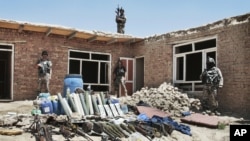 Arms and ammunition belonging to militants are displayed after they were killed during a gun battle with Afghan security forces on the outskirts of Kabul, Afghanistan, August 2, 2012. 
