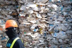 FILE - A container is filled with plastic waste from Australia, in Port Klang, Malaysia, May 28, 2019.