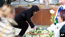 Nidhi Chaphekar, Jet Airways flight attendant and a victim of the Brussels airport terror attack, lays a rose on a memorial in Brussels, March 22, 2017. Belgian leaders, victims and families of those who died in the suicide bomb attacks on the Brussels airport and subway are marking the first anniversary of the attacks, which killed 32 people and wounded more than 300 others. 