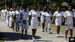 FILE - Members of dissident group Ladies in White take part in their weekly march in front of Santa Rita church in Havana, Cuba, March 18, 2012. U.S. President Barack Obama vowed to discuss human rights issues with Cuban leader Raul Castro.