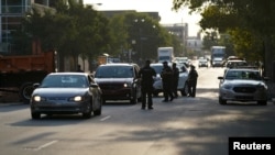Police officers operate a check point and control vehicle access to downtown as the community awaits the findings of the grand jury in the case of Breonna Taylor in Louisville, Kentucky, Sept. 22, 2020.