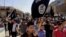FILE - Demonstrators chant pro-Islamic State group slogans as they wave the group's flags in front of the provincial government headquarters in Mosul, Iraq, June 16, 2014.