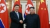 Pemimpin Korea Utara Kim Jong Un berjabat tangan dengan Presiden China Xi Jinping selama kunjungan Xi di Pyongyang, Korea Utara dalam foto tak bertanggal yang dirilis pada 21 Juni 2019. (Foto: KCNA via REUTERS)