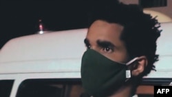 In this screen grab taken from Cuban TV handout footage, Cuban dissident artist Luis Manuel Otero Alcantara is being taken by medical personnel to the Calixto Garcia Hospital in Havana, May 2, 2021.