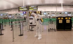 A member of the Military Emergency Unit disinfects the Josep Tarradellas Barcelona-El Prat Airport during a partial lockdown, part of a 15-day state of emergency to combat the coronavirus, in Barcelona, Spain, March 19, 2020.