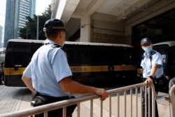 A prison van carrying Tong Ying-kit, the first person charged under the new national security law, arrives at High Court for a hearing, in Hong Kong, July 27, 2021.