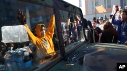 Protesters stand near a Minnesota National Guard vehicle May 29, 2020, in Minneapolis. Protests continued following the death of George Floyd, who died after being restrained by Minneapolis police officers on Memorial Day. 
