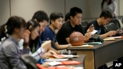 FILE - Weikang Nie, a finance graduate student from China, attends a new student orientation at the University of Texas at Dallas in Richardson, Texas Aug. 22, 2015. (AP Photo/LM Otero)