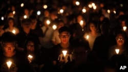 Tens of thousands of people attend an annual candlelight vigil at Hong Kong's Victoria Park, Monday, June 4, 2018. 