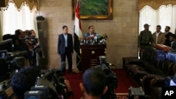 The spokesman of the Shi'ite rebels known as Houthis, Mohammed Abdel Salam, center, speaks at a press conference prior to the departure of the Houthi delegation for the Geneva peace talks, in Sana'a, Yemen, Dec. 12, 2015. 