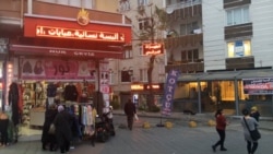 Syrian refugees are seen near stores in Istanbul. With Turkey hosting more Syrian refugees than any other country, President Recep Tayyip Erdogan is calling for more European support. (Dorian Jones/VOA)