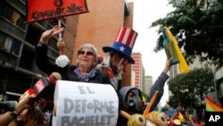 Government supporters march with effigies depicting Michelle Bachelet, U.N. high commissioner for human rights, and Uncle Sam, during a protest in Caracas, Venezuela, Saturday, July 13, 2019. 