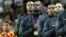 Lebron James (C) of the U.S. and teammates listen to the national anthem during victory ceremony at the North Greenwich Arena during the London 2012 Olympic Games August 12, 2012. 